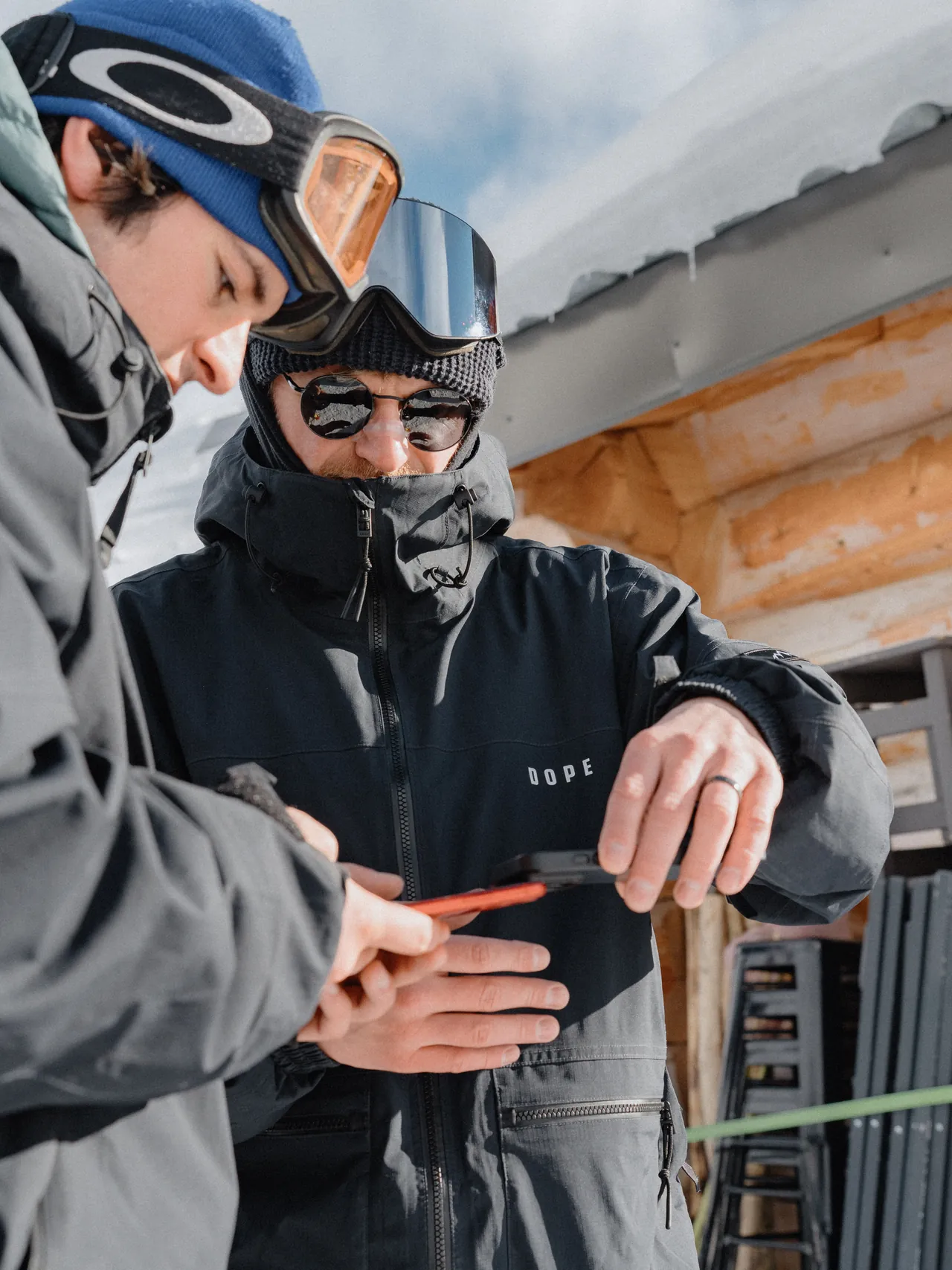 Tom helping a client with their phone at an Alpine ski resort